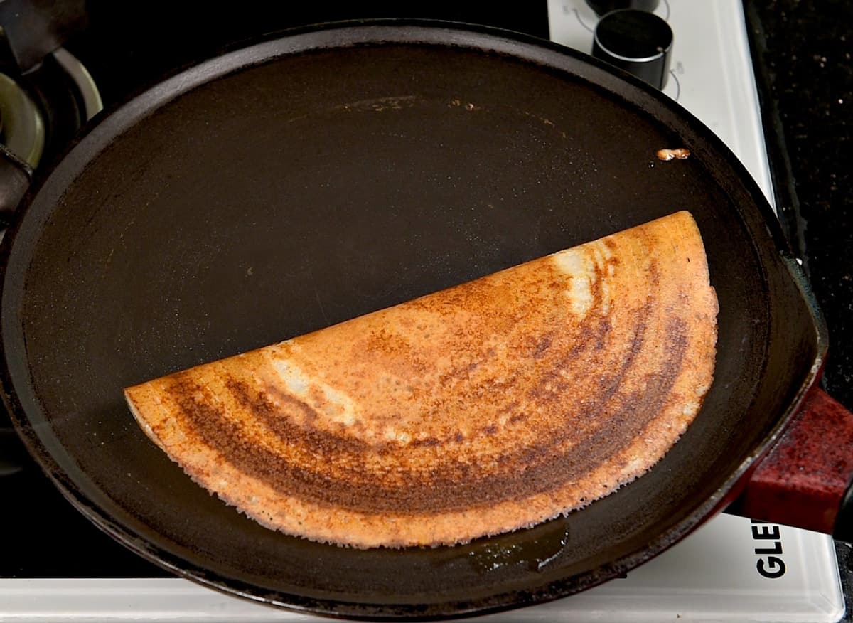 A folded crispy sada dosa ready to be served.