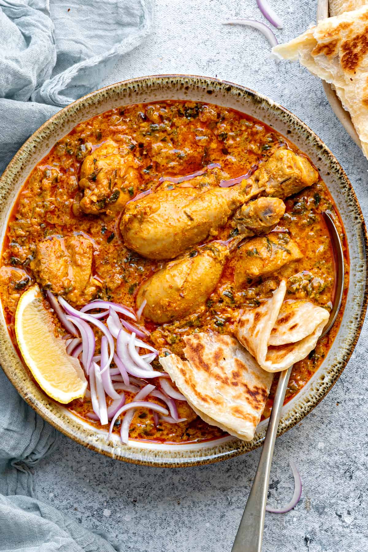 Close-up of methi chicken curry served in bowl.