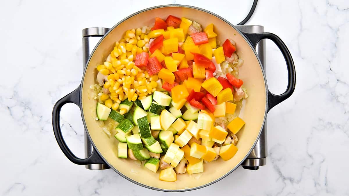 Diced, zucchinis, bell peppers and corn added to the pot.