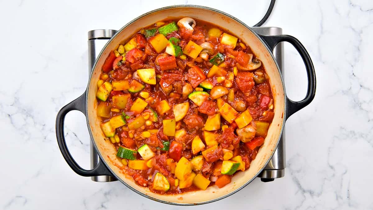 Tomato paste combined well and veggies are cooking in the pot.