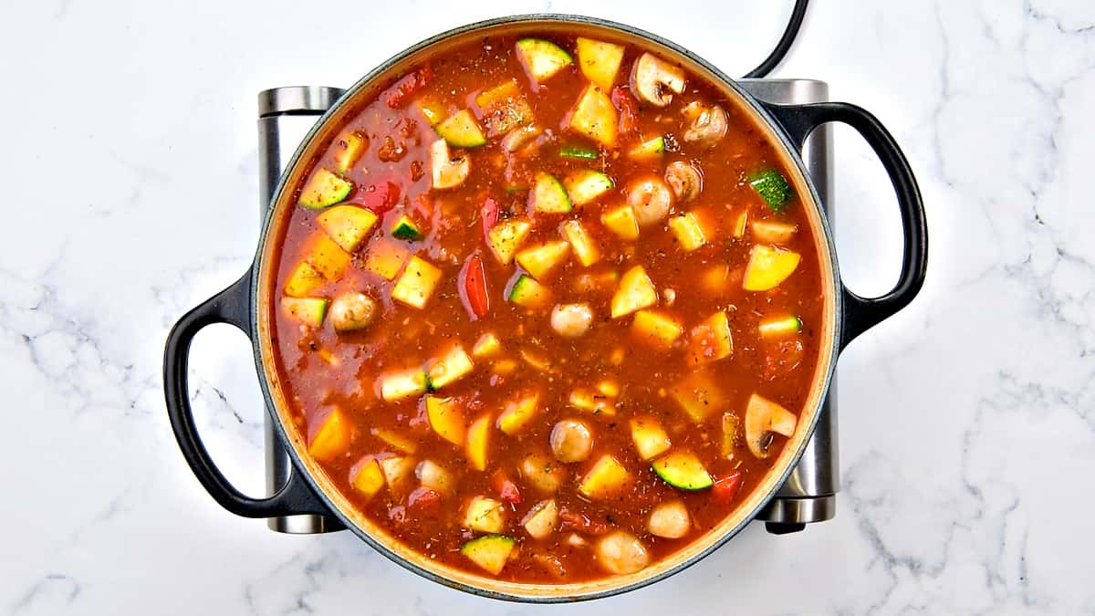 Vegetable stock added to the pot.