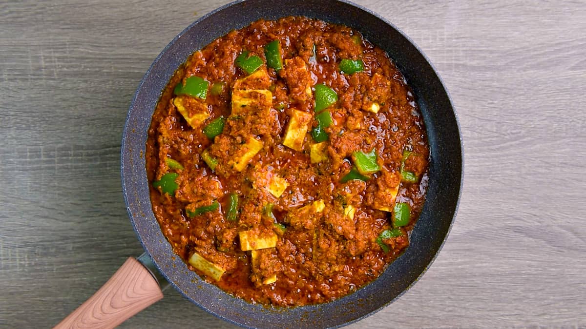 Cooked  paneer masala in the skillet ready to serve. 