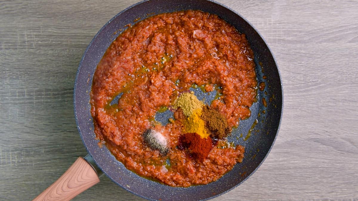 Ground spices added to the sautéed onion tomato mixture to make the tawa masala base.