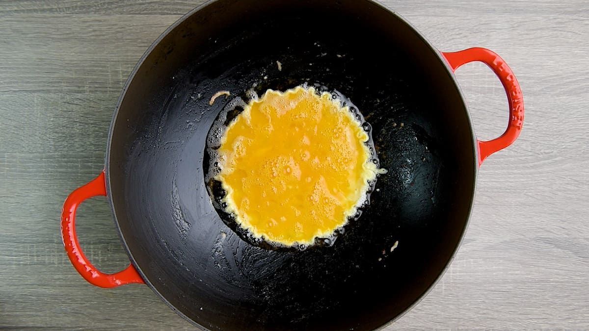 Scrambled egg mixture in a wok.