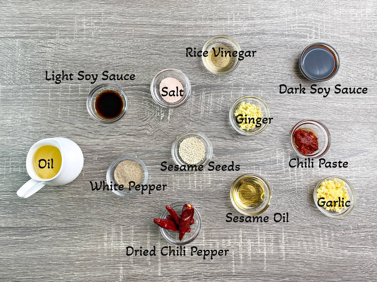 Recipe ingredients in individual glass dishes - oil, vinegar, sauces and seasonings.