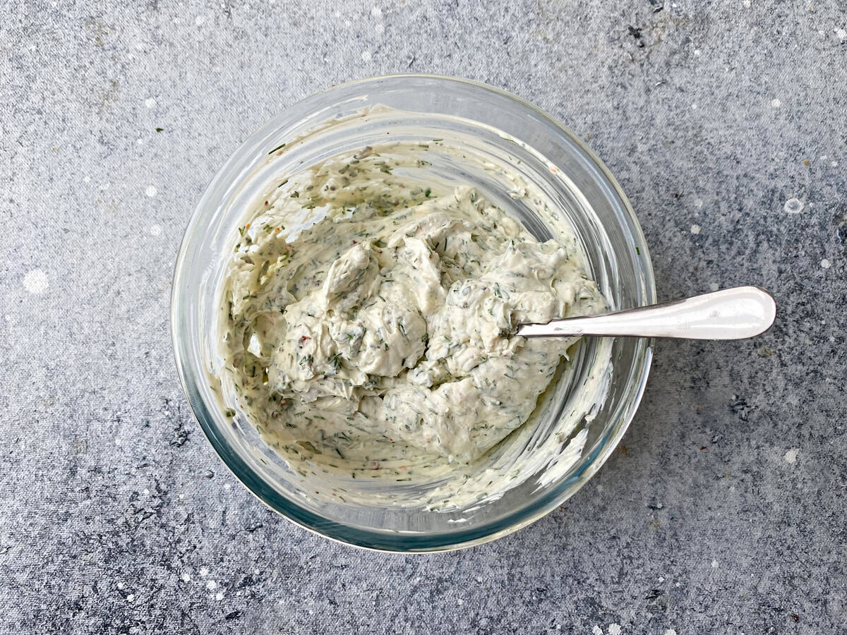 Glass bowl with mixed cream cheese and herb filling.
