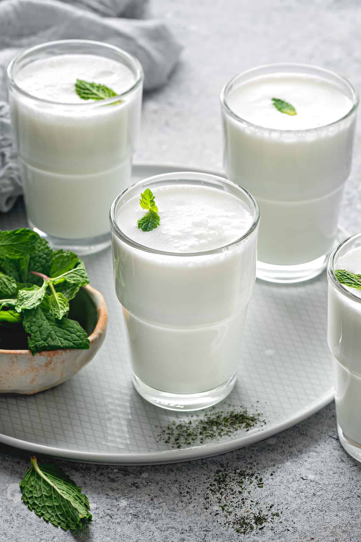 3 glasses of ayran drink with fresh mint.