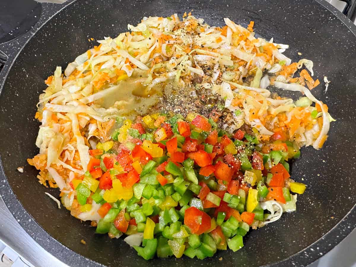 Add chopped bell peppers, soy sauce, green chilli sauce, salt and pepper to the skillet.