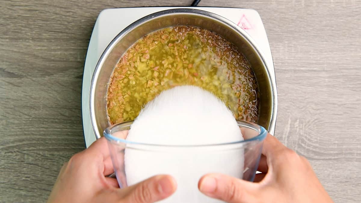 Adding the sugar to the sauce pan.