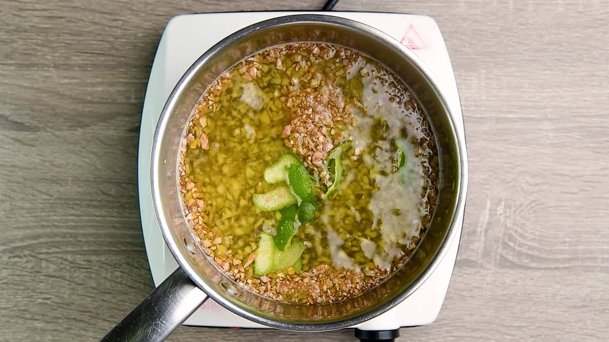 The pot of ginger syrup steeping with the lime peels.