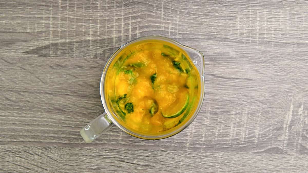 muddled mango mixture topped with mango juice and simple syrup