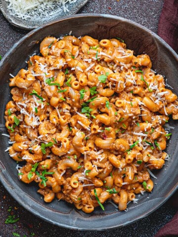 Top down view of a gray bowlful of creamy ground beef pasta.