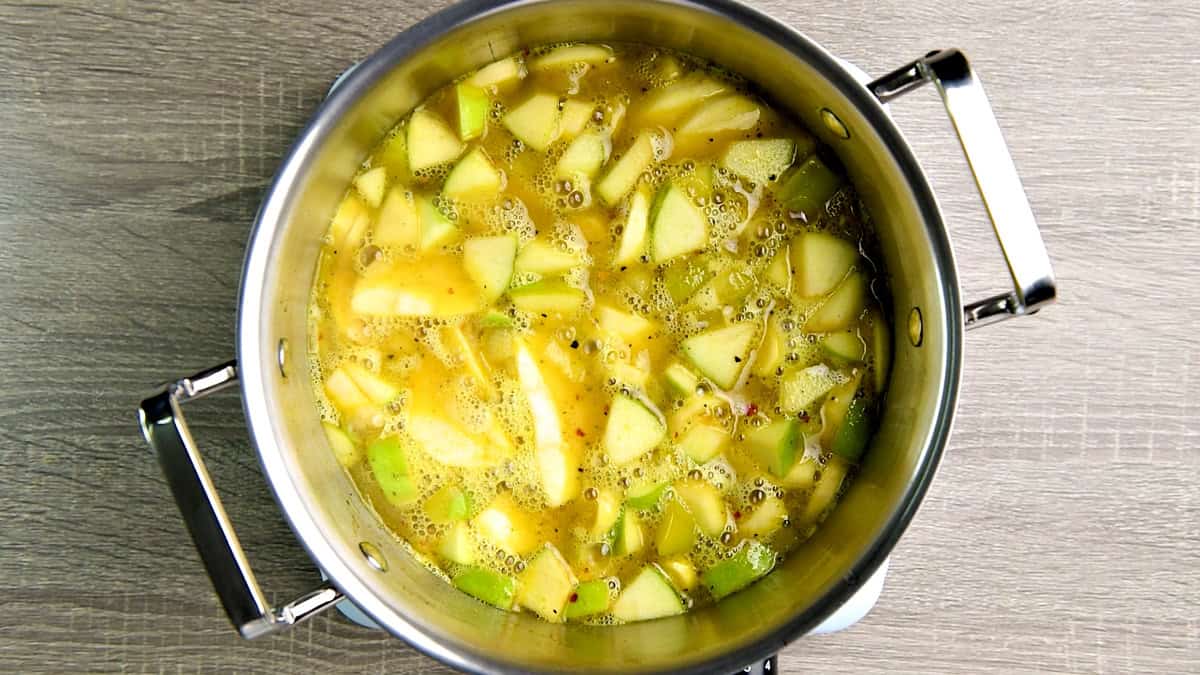 Chicken stock added to the pot to simmer further until the veggies are cooked.