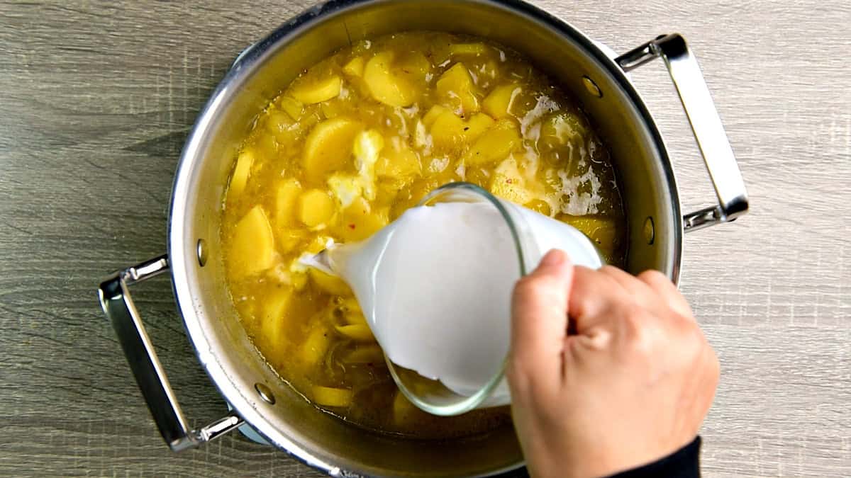 Lime juice and coconut milk added to the simmering soup pot.