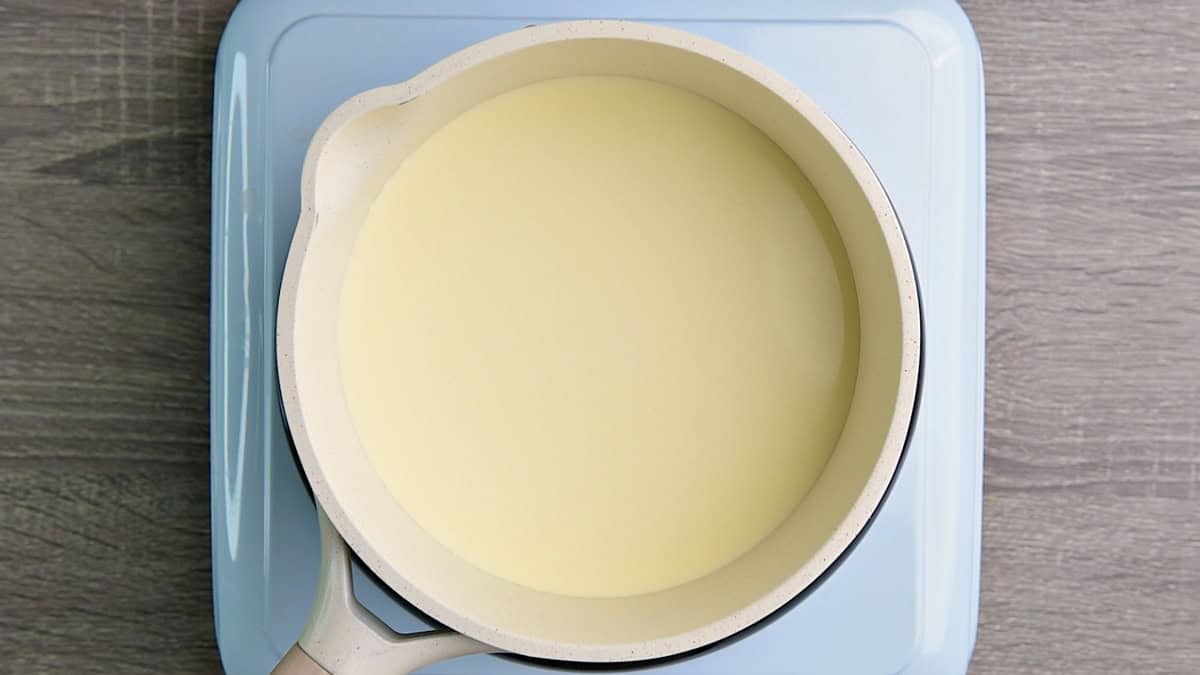 Heavy cream in a pot being warmed on a hot plate for sour cream.