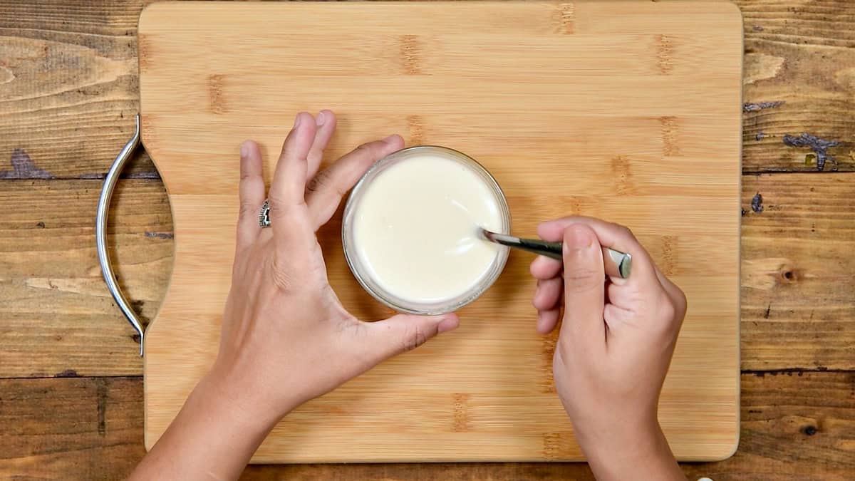 Top-down view of flour and water whisked into a smooth paste for sealing rolls.