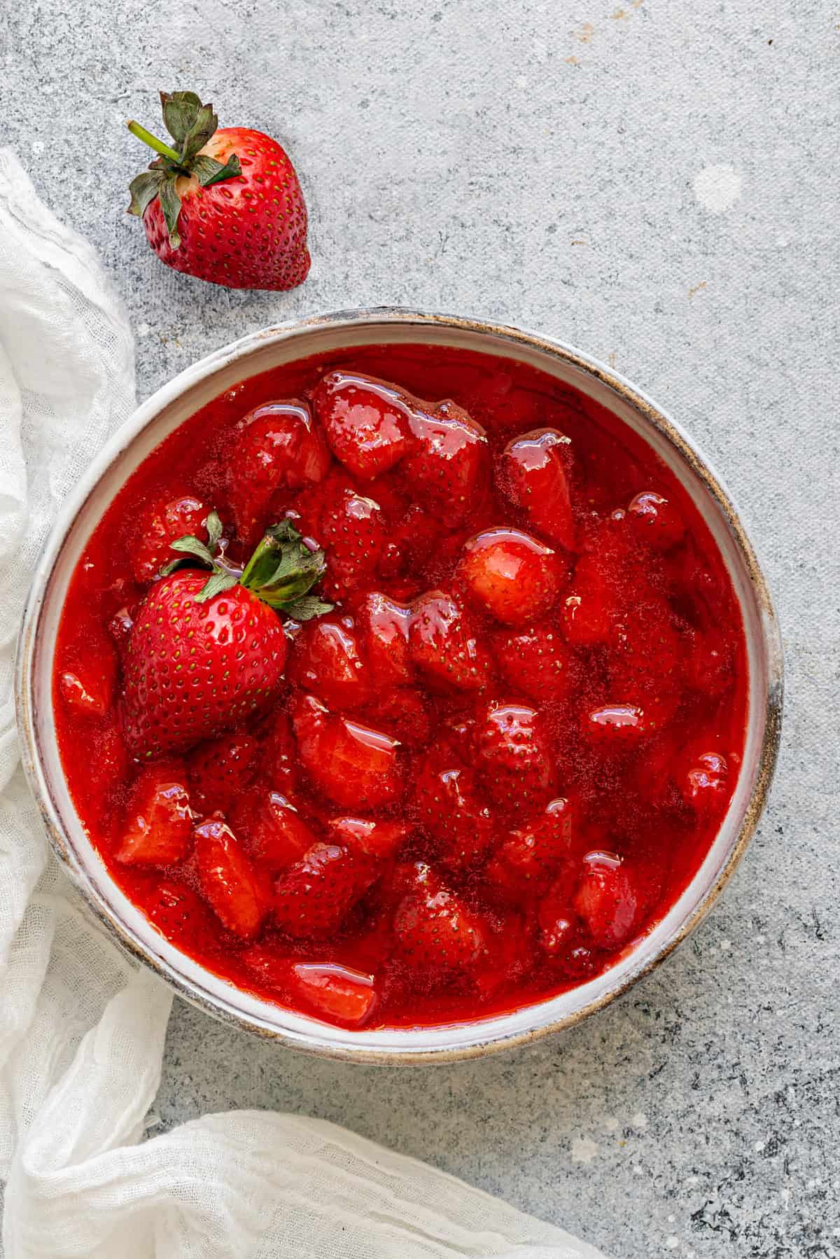 Strawberry topping sauce in white earthen bowl ready to be served.
