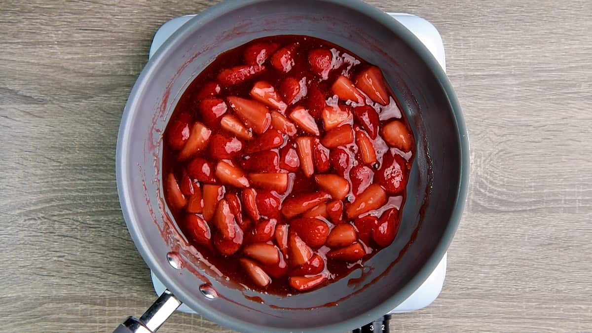The strawberries and cornstarch mixture has been simmered and is now soft and glazed, and ready to be used as a topping.