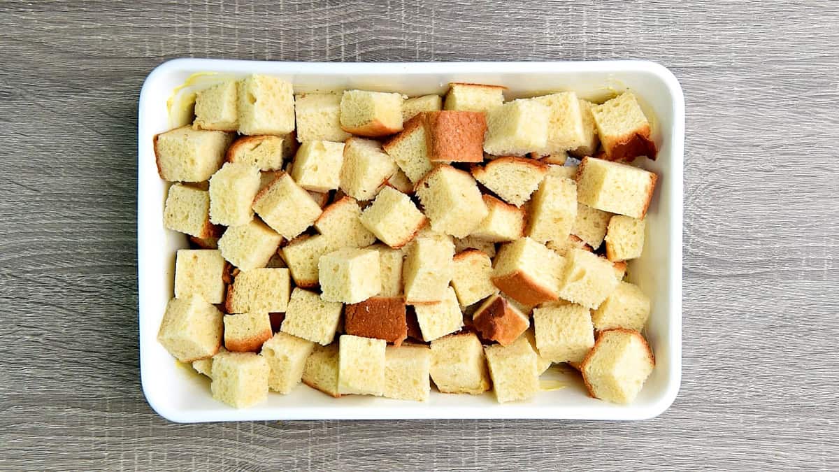 Cubed brioche in a 9x13 baking dish.
