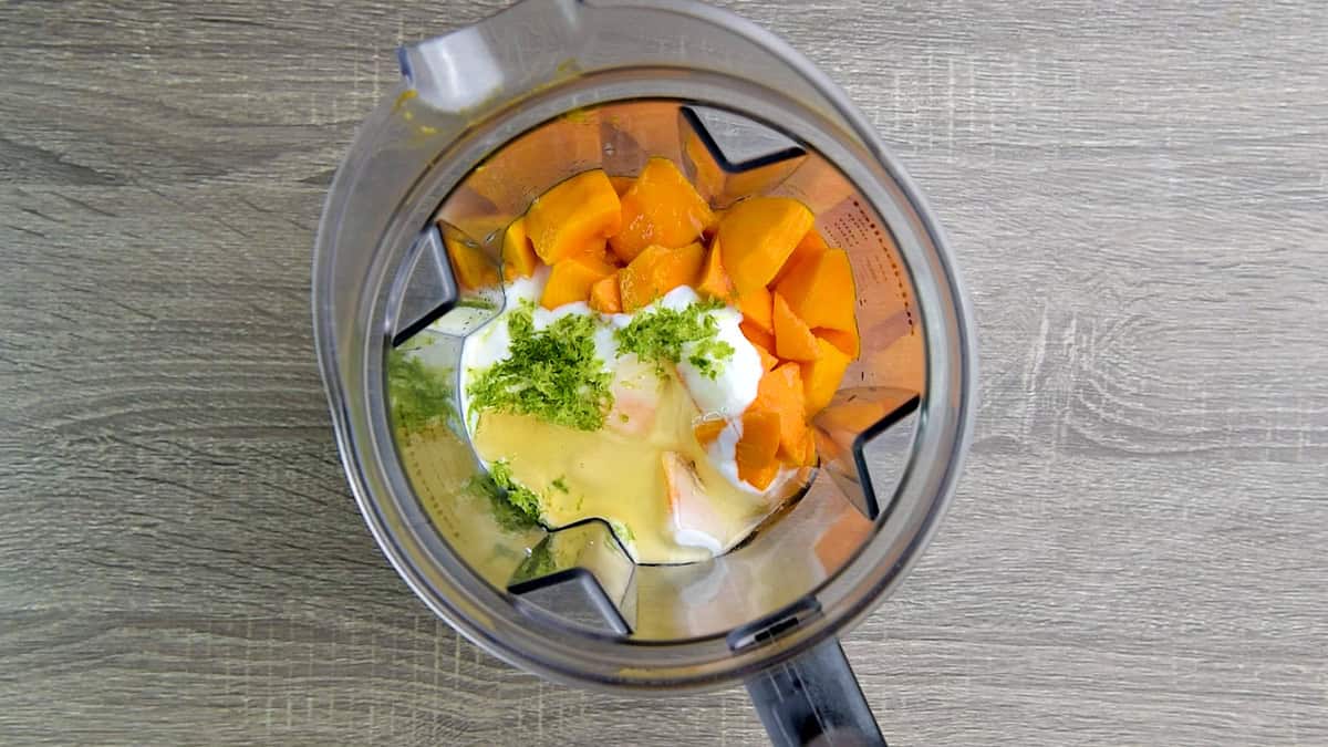 Mango, lime zest, honey, yogurt and lime juice to a high speed blender jar.