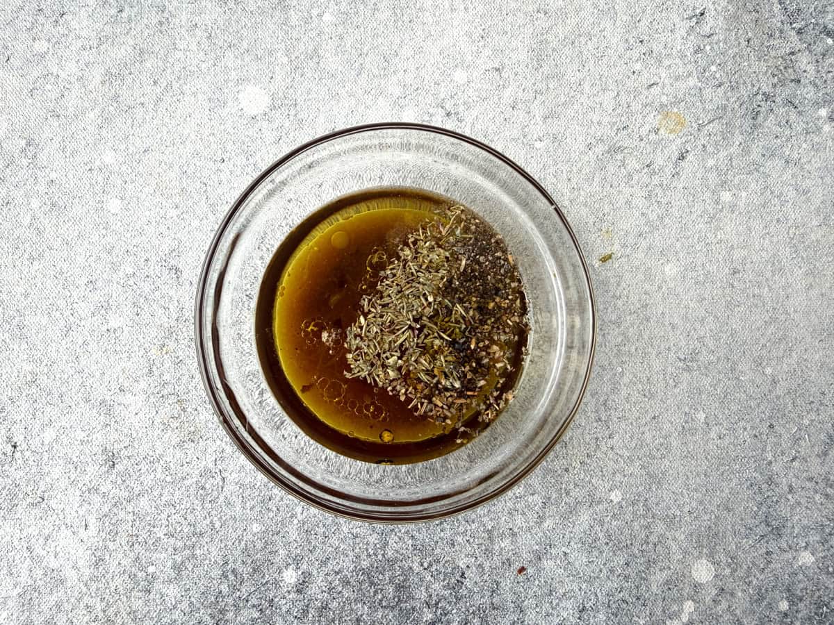 EVOO, balsamic vinegar, lemon juice, honey, and spices in a small bowl to be used for the vinaigrette.