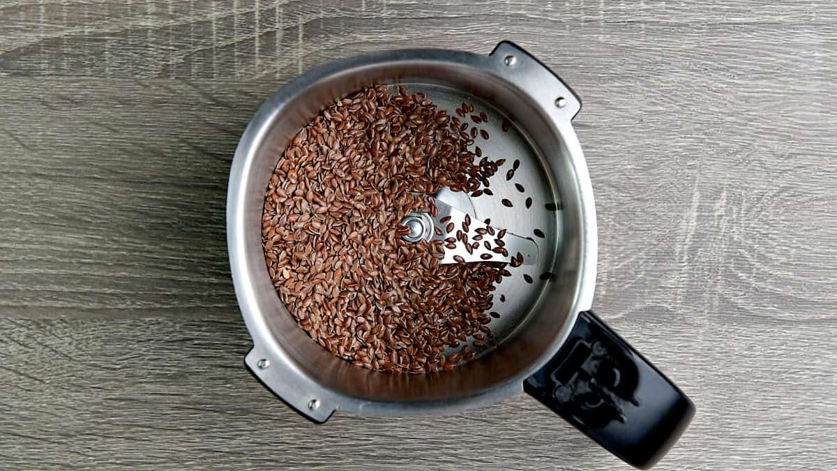 Top-down view of flax seed in a high-speed blender jar.