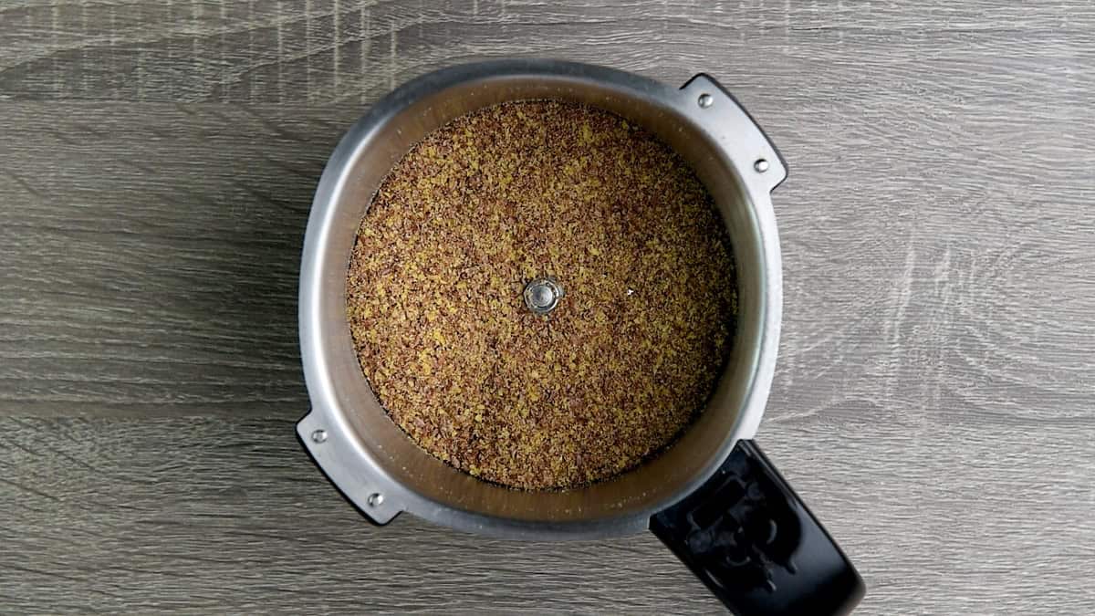 Flax seed ground into a coarse powder inside a grinder jar.