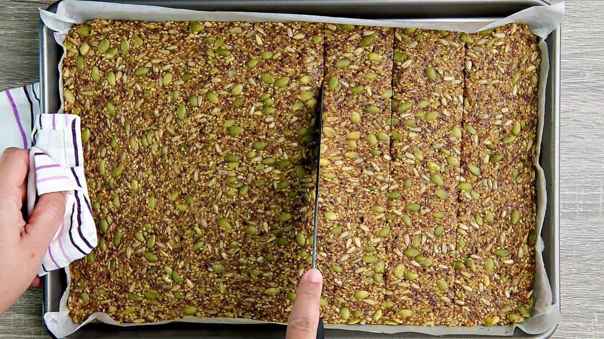 The seed crackers half way baked and scored for easier breaking later.