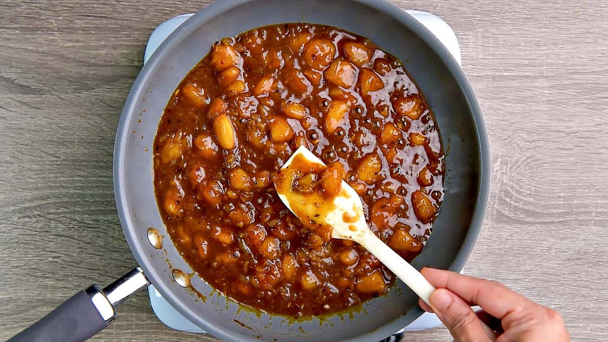 Peaches, and all mixed and simmered well and turned chutney in the pan with a spoon ladling for serving or storing.